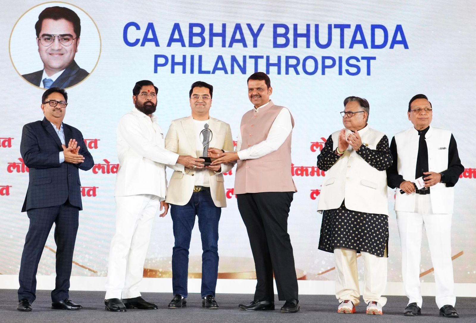 CA Abhay Bhutada, Chairman of the Abhay Bhutada Foundation and TAB Global Ventures, received the Philanthropist of the Year Award 2026 from Devendra Fadnavis and Eknath Shinde, in the presence of Rajendra Darda and Vijay Darda